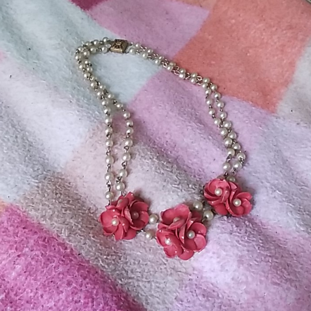 White pearl necklace with red flowers